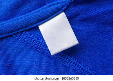 Blank White Laundry Care Clothes Label On Blue Fabric Texture Background