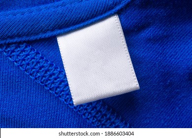 Blank White Laundry Care Clothes Label On Blue Fabric Texture Background