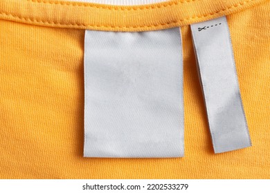 Blank White Laundry Care Clothes Label On Yellow Fabric Texture Background