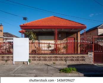 Blank White Mock Up Template Of A Real Estate Advertisement Billboard Sign At Front Of A Typical Residential House In An Australian Suburb.