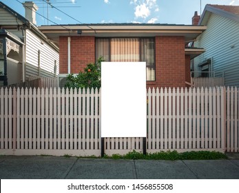 Blank White Mock Up Template Of A Real Estate Advertisement Billboard/sign/board At Front Of A Typical Residential Brick House In An Australian Suburb.