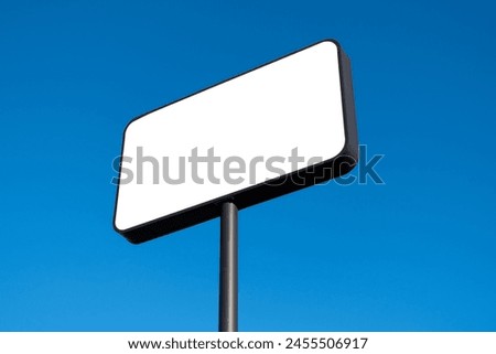A blank white mockup background texture of a large billboard isolated against the blue sky in natural sunlight. Copy space for commercial advertisement display or shop sign on the side of the highway.