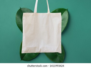 Blank White Mockup Linen Cotton Tote Bag On Green Leaves Foliage Background. Zero Waste Reusable Nature Friendly Materials. Environmental Conservation Recycling Plastic Free Concept