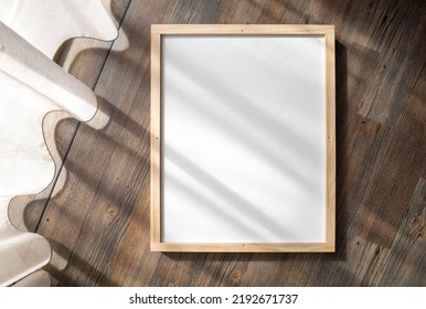 Blank White Mockup Template Of A Vertical 40x50cm Poster Canvas Or Picture With A Pinewood Frame. Background Texture Of Elegant Wall Art Display Placed On Wooden Floor With Curtain Shadow Overlay.