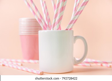 Blank White Mug Mockup on Pink Background. Template Space for Creative Artwork Lettering Text Product Promotion Branding. Elegant Feminine Style. Birthday Party Decoration Straws