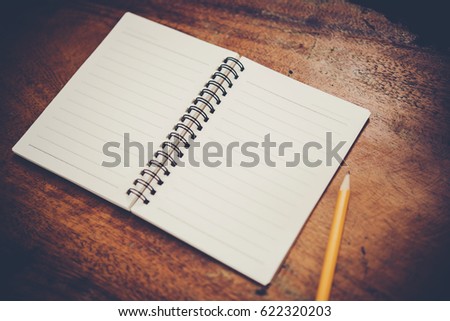 Blank white notebook with copy space on wood table background.
