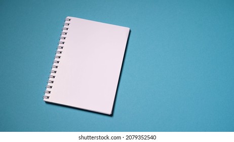 Blank, White Notebook And Pen On A Turquoise Solid Background. Notebook, Notebook For Notes.
