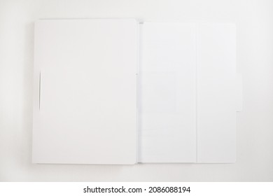 Blank White Operations Manual On White Background, A Laptop Manual Book. User Guide. Operation Manual For Electronic Device, Equipment. Open Use Specification Brochure.