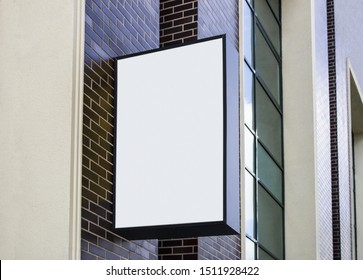 Blank White Outdoor Box With Black Frame Mockup Wall Mounted. Empty Advertise Lightbox On Building Mock Up. Clear Vertical Hanging Signboard On Brick Wal Mokcup Template.