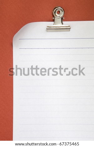 blank white paper on red background with clip