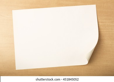 Blank white paper on wood background