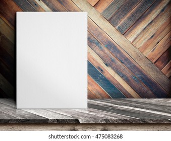 Blank White paper poster on wooden table at diagonal wood plank wall,Template mock up for adding your design and leave space beside frame for adding more text.
