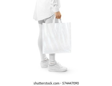 Blank white plastic bag mockup holding hand. Woman hold carrier sac mock up with loop handles. Plain bagful branding template. Shopping carry package in persons arm. Packet for logotype branding.