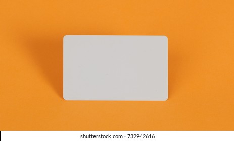 Blank White Plastic Card On Orange Background