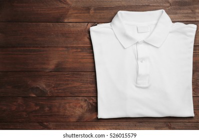 Blank White Polo Shirt On Wooden Background