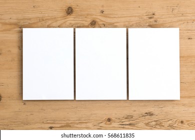 Blank white postcard flyer on a wooden background