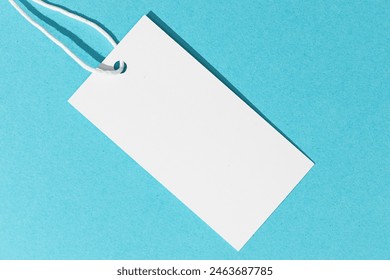 Blank white price tag isolated on blue background. template mock up - Powered by Shutterstock