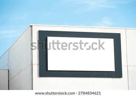 Blank white rectangular advertising board, signage billboard on building wall outdoors. Mockup.