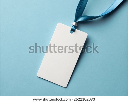 Blank white rectangular card with rounded corners attached to a blue ribbon on a light blue background – Professional Name Tag and Identification Concept