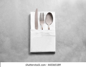 Blank White Restaurant Cloth Napkin Mockup With Silver Cutlery Set, Isolated. Knife Fork And Spoon In Clear Textile Towel Mock Up Template. Cafe Branding Identity Clean Napkin Surface For Logo Design.