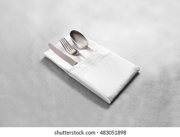 Blank White Restaurant Cloth Napkin Mock Up With Silver Cutlery Set, Isolated. Knife Fork And Spoon In Clear Textile Towel Mockup Template. Cafe Branding Identity Clean Napkin Surface For Logo Design.