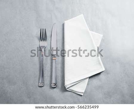 Blank white restaurant napkin mockup with knife and fork, isolated. Cutlery near clear textile towel mock up template. Cafe brand identity overlay surface for logo design.