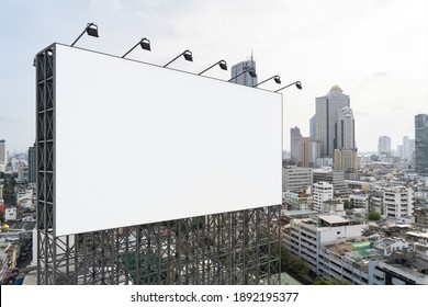 Blank white road billboard with Bangkok cityscape background at day time. Street advertising poster, mock up, 3D rendering. Side view. The concept of marketing communication to promote or sell idea. - Shutterstock ID 1892195377
