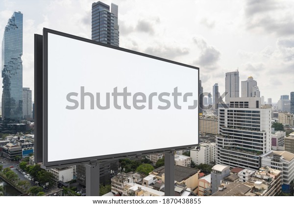 Blank white road billboard with Bangkok cityscape\
background at day time. Street advertising poster, mock up, 3D\
rendering. Side view. The concept of marketing communication to\
promote or sell idea.