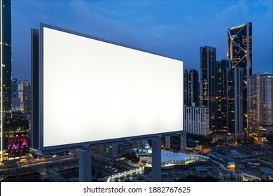 Blank white road billboard with KL cityscape background at night time. Street advertising poster, mock up, 3D rendering. Side view. The concept of marketing communication to promote or sell idea. - Shutterstock ID 1882767625