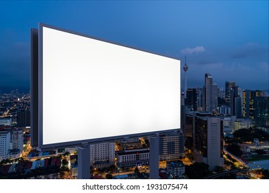 Blank white road billboard with KL cityscape background at night time. Street advertising poster, mock up, 3D rendering. Side view. The concept of marketing communication to promote or sell idea. - Shutterstock ID 1931075474