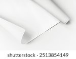 Blank white rolled chart paper on a gray background