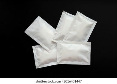 Blank White Sachet Packets Stack Mockup Isolated On Black Background. Empty Airtight Pack Mock-up For Sauce, Coffee, Wet Wipe, Mayonnaise.