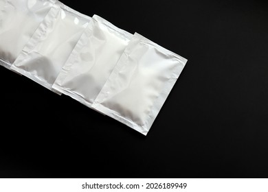 Blank White Sachet Packets Stack Mockup Isolated On Black Background. Empty Airtight Pack Mock-up For Sauce, Coffee, Wet Wipe, Mayonnaise.