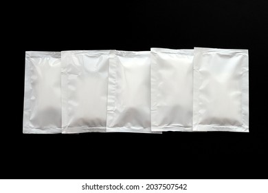 Blank White Sachet Packets Stack Mockup Isolated On Black Background. Empty Airtight Pack Mock-up For Sauce, Coffee, Wet Wipe, Mayonnaise.