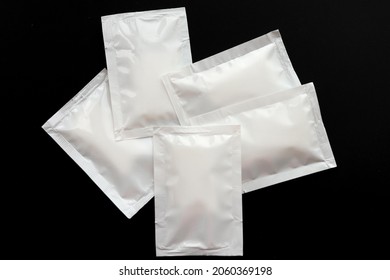 Blank White Sachet Packets Stack Mockup Isolated On Black Background. Empty Airtight Pack Mock-up For Sauce, Coffee, Wet Wipe, Mayonnaise.