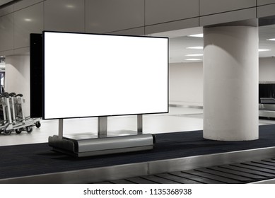 Blank White Screen Advertising Sign At Baggage Claim Conveyor In The Airport.