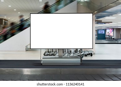 Blank White Screen Advertising Sign At Baggage Claim Conveyor In The Airport.