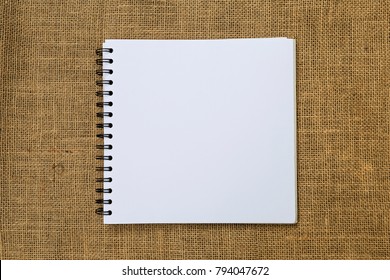 Blank White Sketch Book On Hessian Texture Background