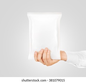 Blank White Snack Bag Mock Up Hold In Hand Isolated. Clear White Chips Pack Mockup. Cookie, Candy, Sugar, Cracker, Nuts, Supermarket Foil Frozen Plastic Container Ready For Logo Design Presentation.