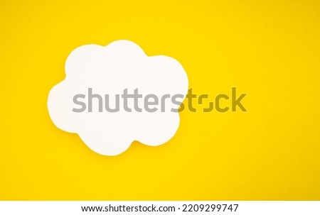 A blank white speech bubble clouds over a light yellow background. Conversation bubble. Space for text. Top view