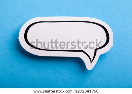 Blank white speech bubble isolated on blue background.