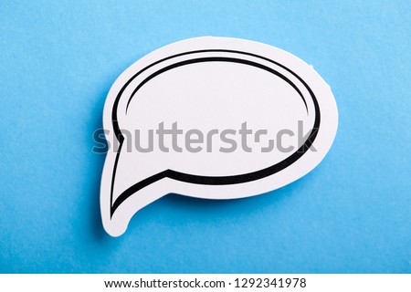 Blank white speech bubble isolated on blue background.