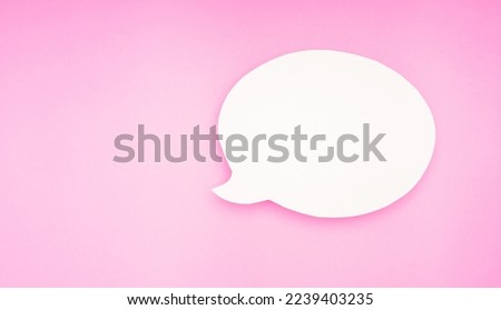 A blank white speech bubble on a pink background. Space for text. Top view