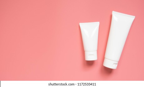 Blank White Squeeze Bottle Plastic Tube With Flip Top Cap On Pink Background. Packaging Of Cream, Body Lotion, Gel, Facial Foam Or Skincare. Cosmetic Beauty Product Branding Mock-up. Copy Space.