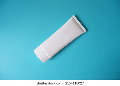 A Blank White Squeeze Bottle Plastic Tube On Blue Background. Packaging Of Cream, Lotion, Gel, Facial Foam Or Skincare. Cosmetic Beauty Product Branding Mock-up. Copy Space