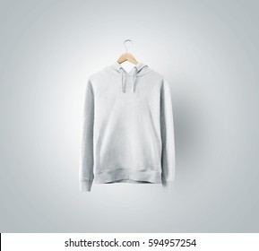 Blank white sweatshirt mockup hanging on wooden hanger. Empty sweat shirt mock up on rack isolated. Clear cotton hoody template. Plain textile hoodie design presentation. Loose overall casual jumper.