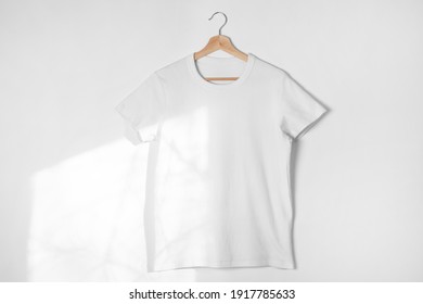 Blank White T-shirt Against Light Grey Background. Mock-up For Branding. 