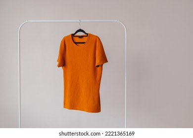 Blank White T-Shirt Mock-up hanging on white Rack Hanger, front view - Shutterstock ID 2221365169