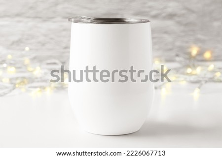 Blank white wine tumbler with lid mockup with light in white gray background. Minimalist style, front view, white copy space. Drinkware, svg product mockup, svg product display.