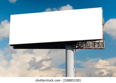 Blank wide white billboard or large display against blue sky with white clouds - mock up. Consumerism, advertising, white screen, template, copy space and mockup concept - Shutterstock ID 2188851301